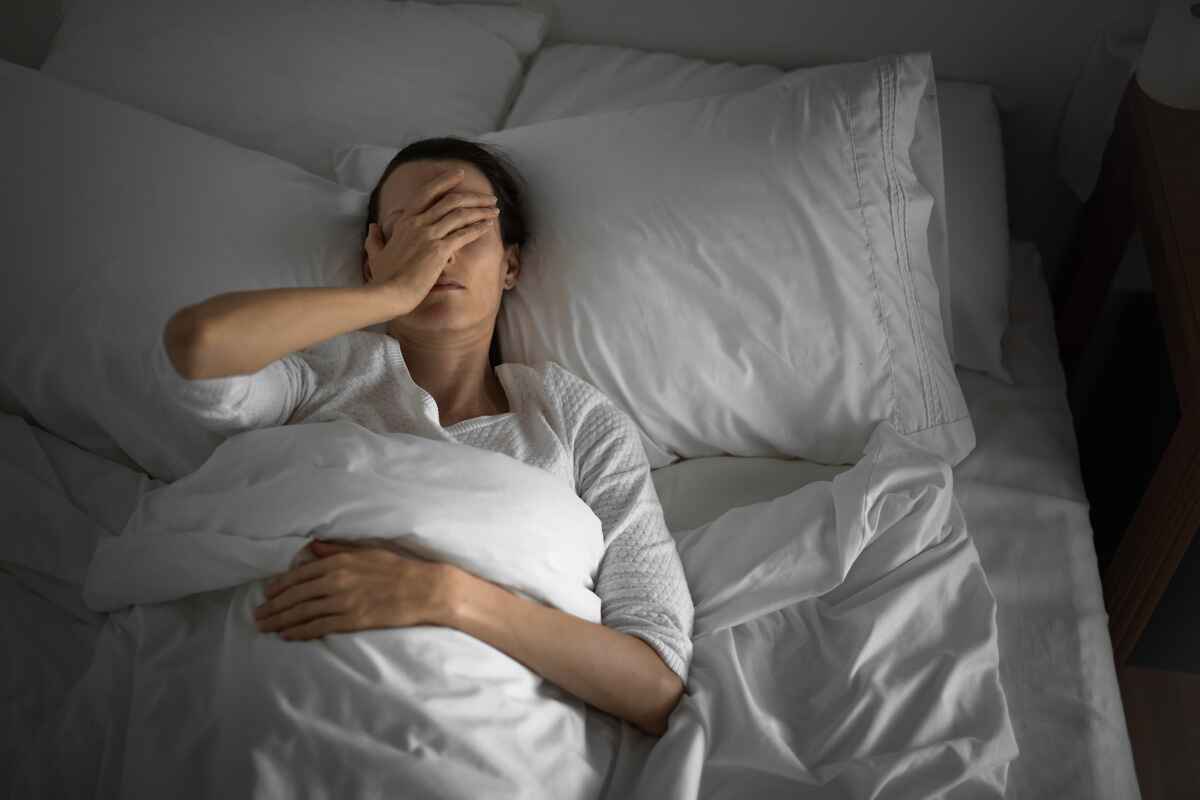 Woman awake in bed having trouble sleeping
