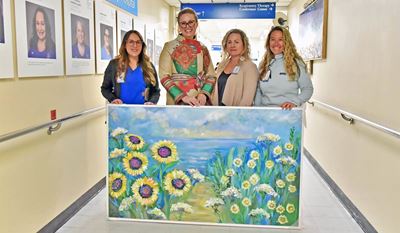 Jeanette Vertentes, second from left, with the painting she donated to Westerly Hospital. With her are (l-r): Ashley Napolitano, RN, Rachael Silvia, RN, director of Patient Care Services, and Jessica Beardsley, RN.