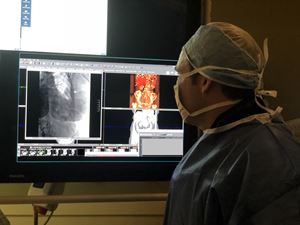 Benjamin May, MD, interventional oncologist uses real-time x-ray fluoroscopy during a Y90 radioembolization